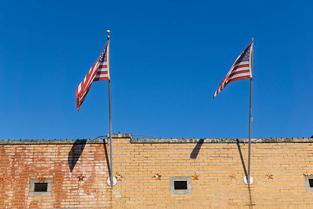 istock American flags flying from a historic brick building 2251240745