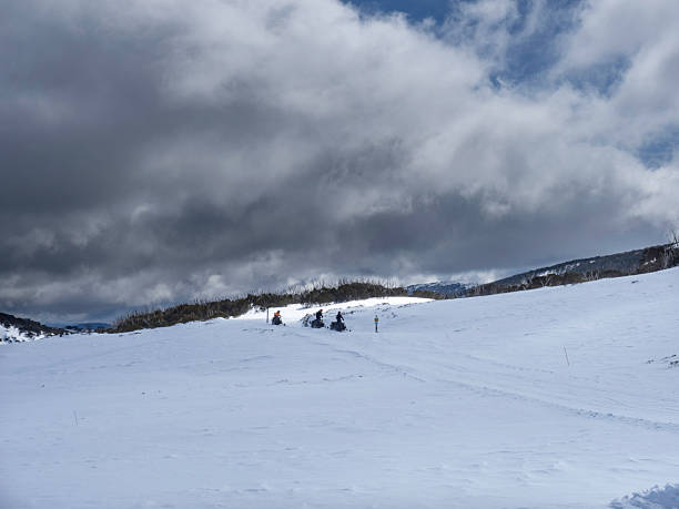 istock Three snow mobiles on stormy day 2251240939