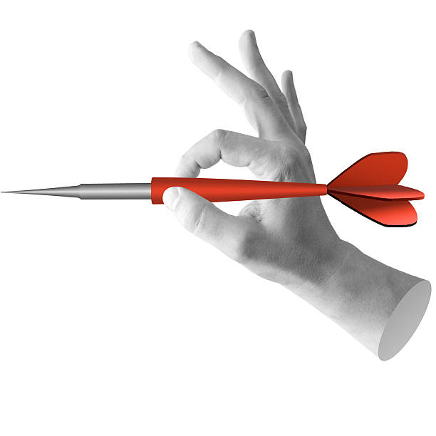 istock Hand holding dart ready to throw. Symbolizes action, targeting, or launching a project. Part of series 2251241594