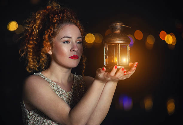 Beautiful young woman holding lantern, holiday fairy tale