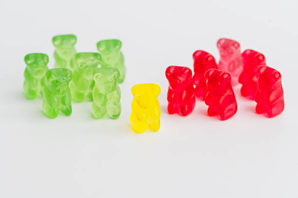 Colorful gummy bears on a white surface during daylight