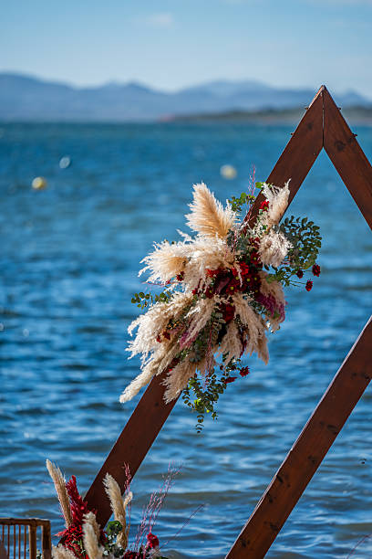 Romantic wedding scene set with beach decorations. Exotic destination wedding concept. Mar Menor, La Manga. La Manga del Mar Menor, Murcia, Spain, Europe - November 15, 2025.