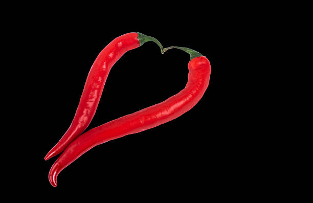 Red hot chili pepper isolated on black background.