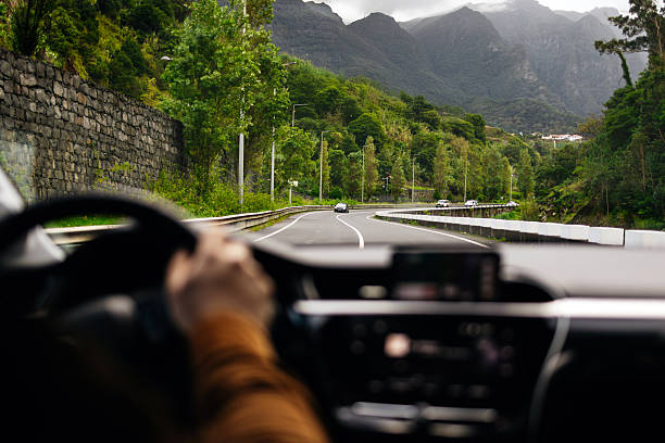 istock Male driver navigating a scenic road with smartphone mounted on dashboard 2251256252