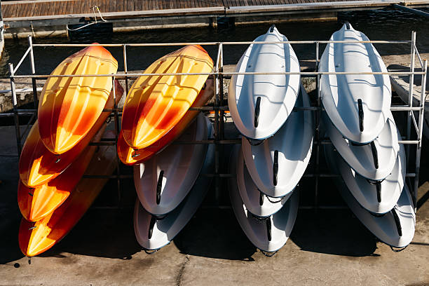istock A rack by the water features stacked kayaks, showcasing their sleek designs 2251256526