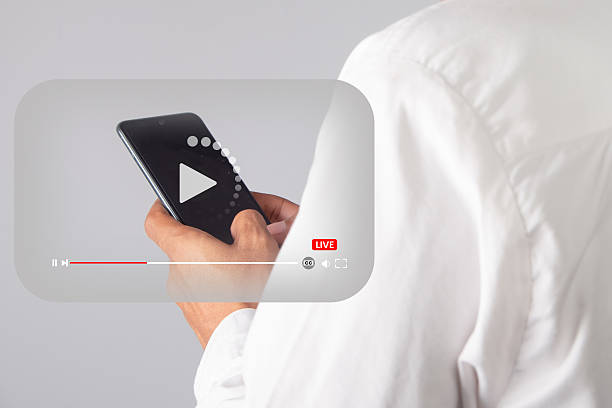 Man in White Shirt Holding Smartphone With Play Button Overlay Media Player Interface