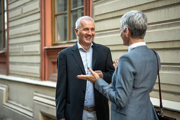 istock Business colleagues having friendly conversation on street 2251256780