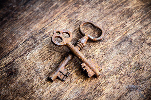 Old rusty keys on a wooden background, high contrast, vitage style.