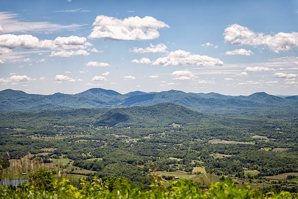 View of a small town in a valley from the Blue Ridge Parkway in Virginia’s Blue Ridge Mountains on a summer day.