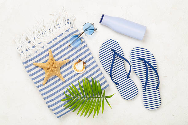 istock Beach towel with summer accessories on concrete background, top view 2251256966