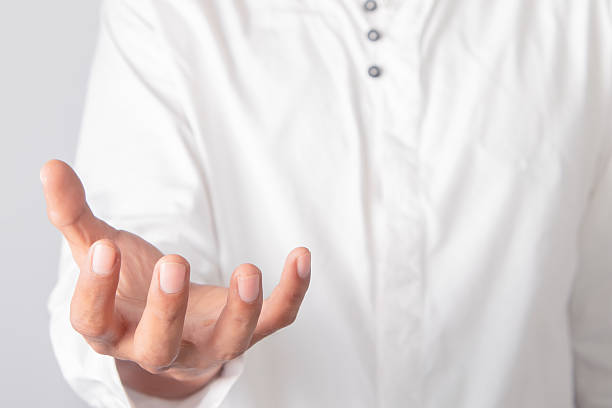 istock Open Hand Receiving Gesture With White Shirt Cuff Against Light Gray Background Studio Shot 2251263492