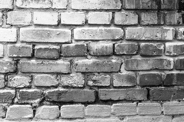 Weathered brick wall in black and white for vintage architecture and textured background concept