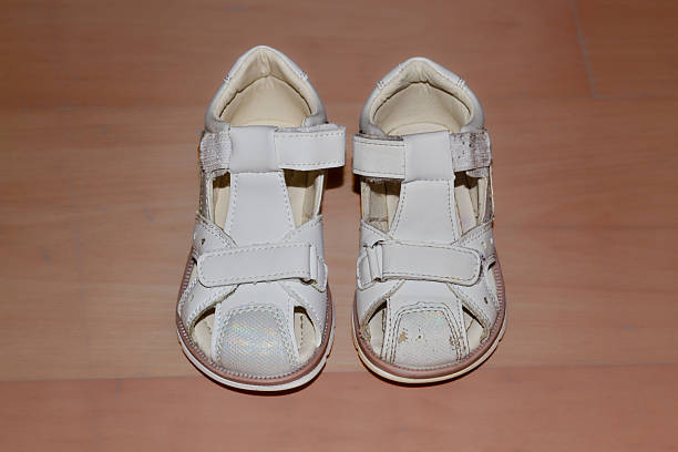 istock Old worn kid's shoe vs a new one 2251263910