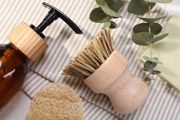 istock Cleaning brush, sponge, dispenser, soap bar and eucalyptus leaves on table, top view 2251267762