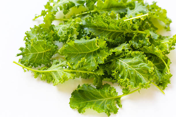 istock Fresh curly green kale leaves on white background. 2251269158