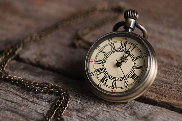 istock Pocket clock with chain on wooden table, closeup 2251269278