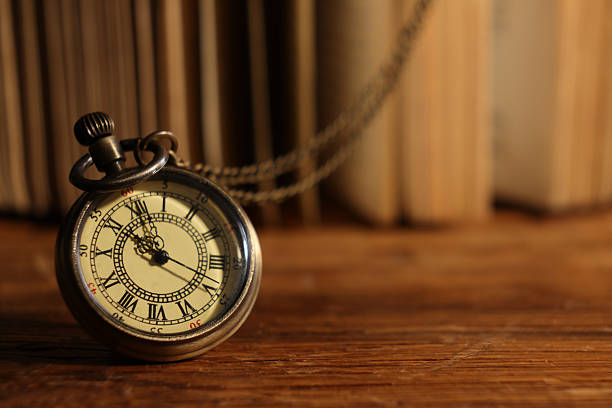istock Pocket clock with chain on wooden table, closeup. Space for text 2251269319