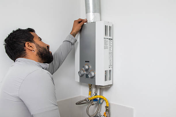istock Man Inspecting Home Water Heater Appliance 2251270442