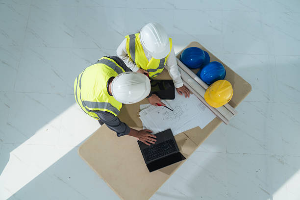 istock Top view-Civil engineer working with interior designer discuss blueprint details at housing site. engineering discussion, housing development and real estate. real estate development progress. 2251271626