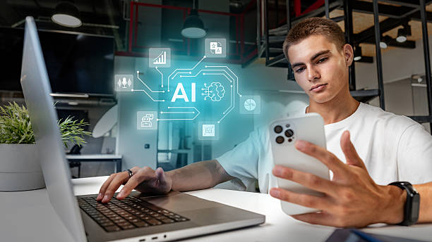 istock Young man engaged in artificial intelligence research while using a laptop and smartphone in a modern office space 2251272069