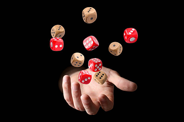 istock Man throwing dice on black background, closeup 2251273128