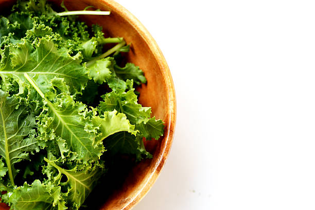 istock Fresh curly green kale leaves on white background. 2251273815