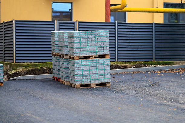 istock Pallets of concrete blocks or paving slabs at construction site on asphalt surface 2251273859