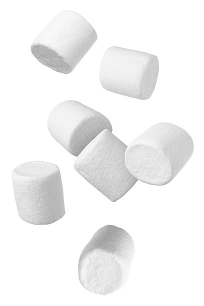 istock Many yummy marshmallows flying on white background 2251275652