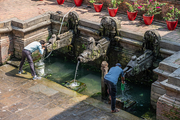 Kathmandu, Nepal : October-14-2023 :  A hiti is an ancient and traditional stone water spout system in Kathmandu.