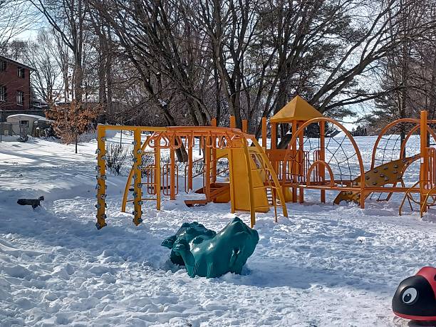 istock Empty children playground covered in snow 2251276481