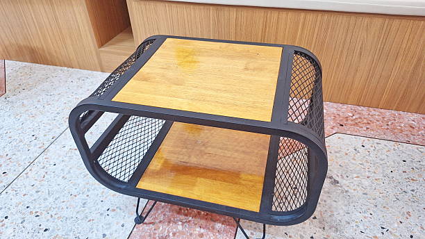 Compact industrial coffee table combining wood panels and metal mesh for stylish modern interior decoration spaces.