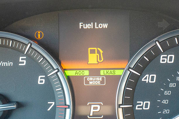 istock Car dashboard with fuel low warning and illuminated indicators 2251278084