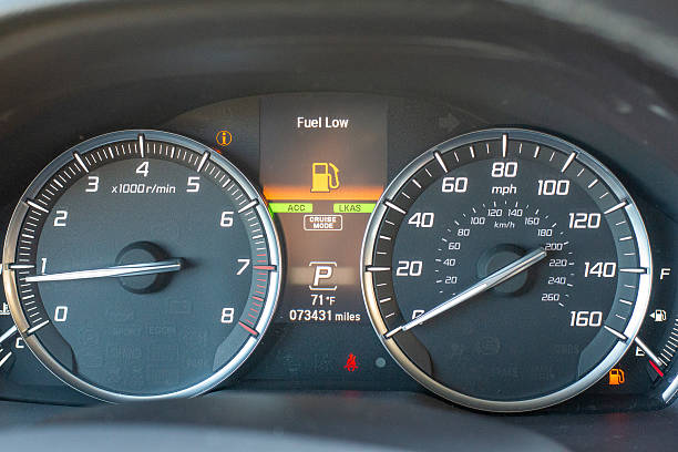 istock Car dashboard with fuel low warning and illuminated indicators 2251278086