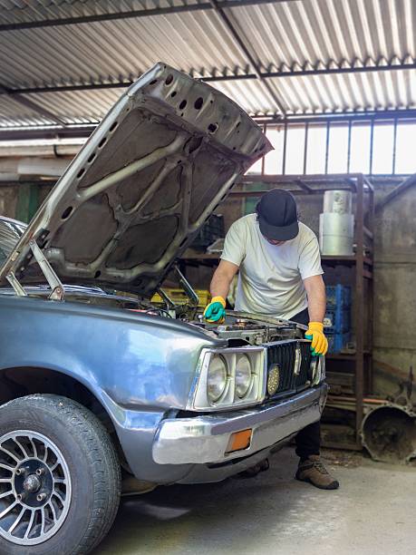 istock Latin man repairs his car at home 2251279756