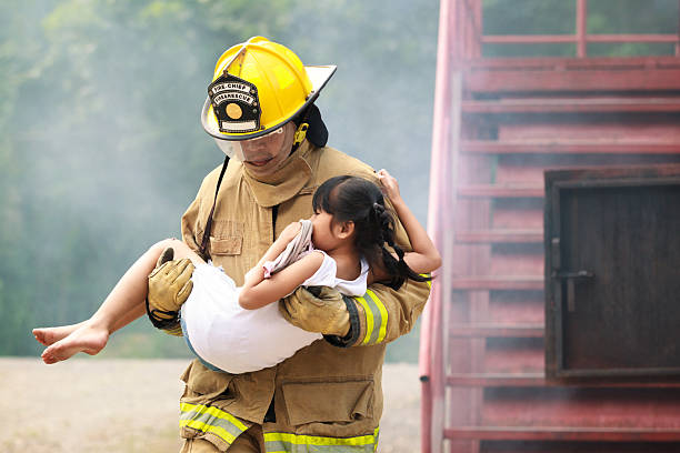 istock Firefighters rescuing a child from smoke-filled or burning building. 2251279955