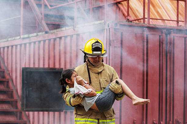 istock Firefighters rescuing a child from smoke-filled or burning building. 2251279956
