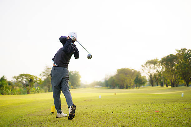 istock Golfer playing a strong tee off swing on a bright morning fairway. 2251279994