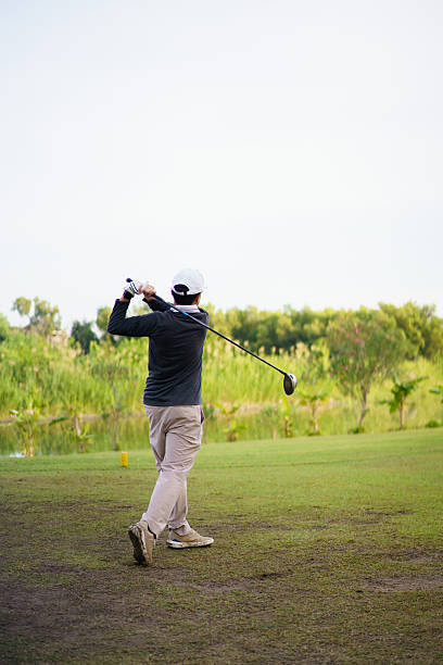istock Golfer playing a strong tee off swing on a bright morning fairway. 2251279998