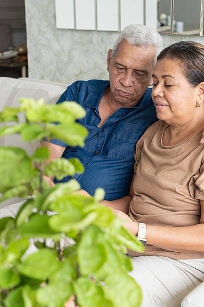 istock Senior couple sharing true love on sofa at home 2251280240