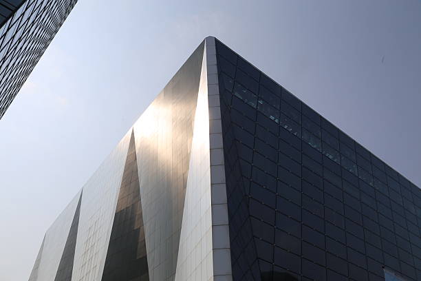 istock the building is made of dark gray metal, with white lines on the surface and a triangular shape that reflects sunlight. 2251281533