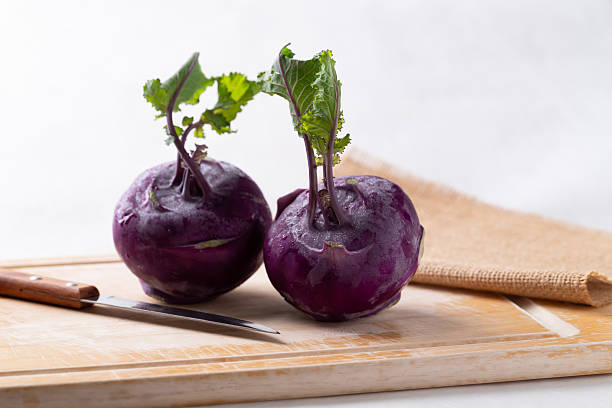 Purple kohlrabi or turnip cabbage on cutting wooden board