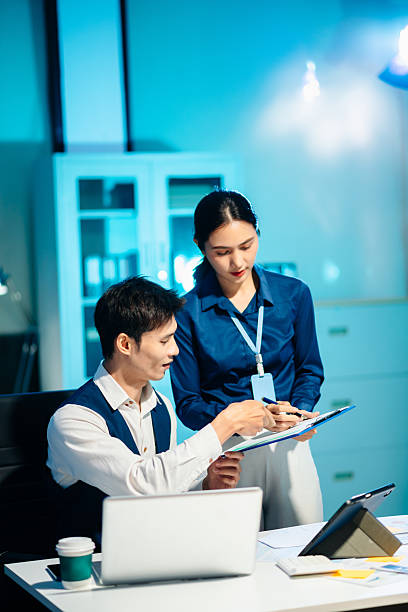istock Asian colleagues discussing project plans and reviewing documents in a modern office. Concept of business teamwork, strategy 2251288277