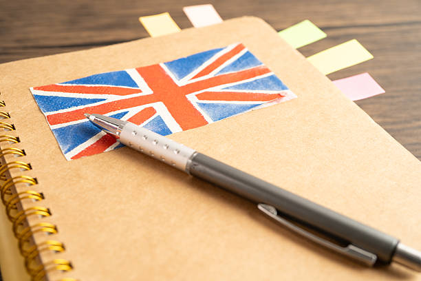 istock UK flag with pen on english language book. 2251288821
