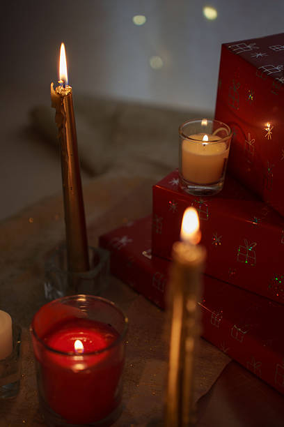 istock warm festive ambiance with glowing candles casting soft light on red gift boxes adorned with delicate patterns, evoking a cozy, celebratory holiday atmosphere, elegant, christmas, corner, evening 2251289435