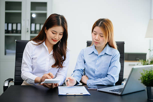 istock Two Asian business discuss investment project working and planning strategy with tablet laptop computer in office 2251296038