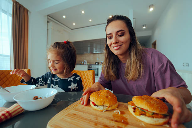 istock Mother and Daughter Eating Breakfast Together 2251297392
