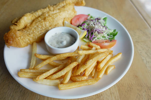 istock Delicious fried fish and chips served with fresh salad 2251298731