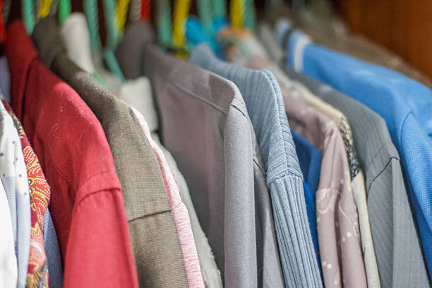 Row of Colorful Clothes Hanging Neatly on a Wardrobe Rack