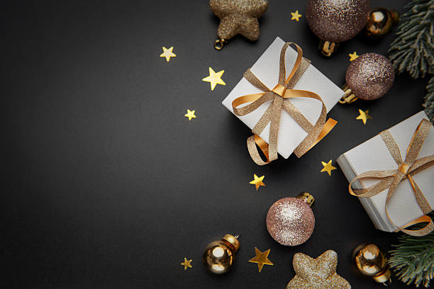 istock Christmas gifts and ornaments on black background 2251299147