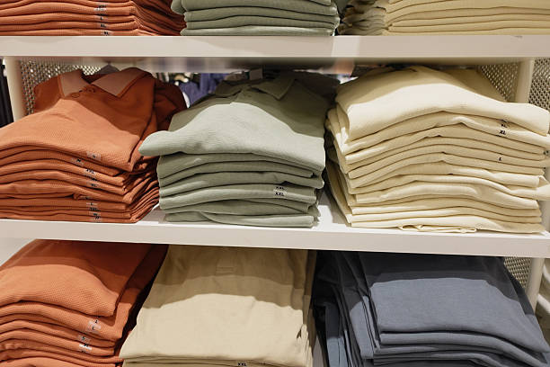 istock Neatly folded polo shirts displayed on retail shelves 2251300045